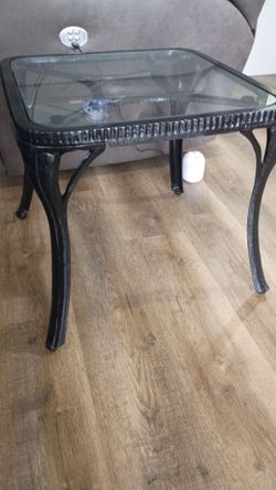Black wrought iron and table with glass top