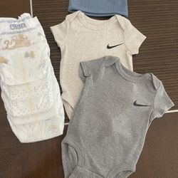 Two NIKE Onesies with hat,five Huggies diapers (size 1)