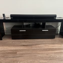 Black glossy entertainment center with storage