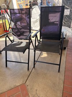 2 reclining black breathable chairs