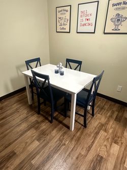 White Dining Table with 4 Blue Chairs