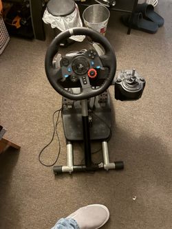 Logitech G29 Driving Force racing wheel attached to a collapsible stand.