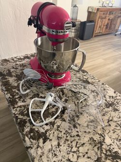 The kitchenAide Artisan Series 5 Qt Stand Mixer Model (KSM150PSCB) in Cranberry is a 10-speed, tilt-head electric mixer featuring a 5-quart stainless