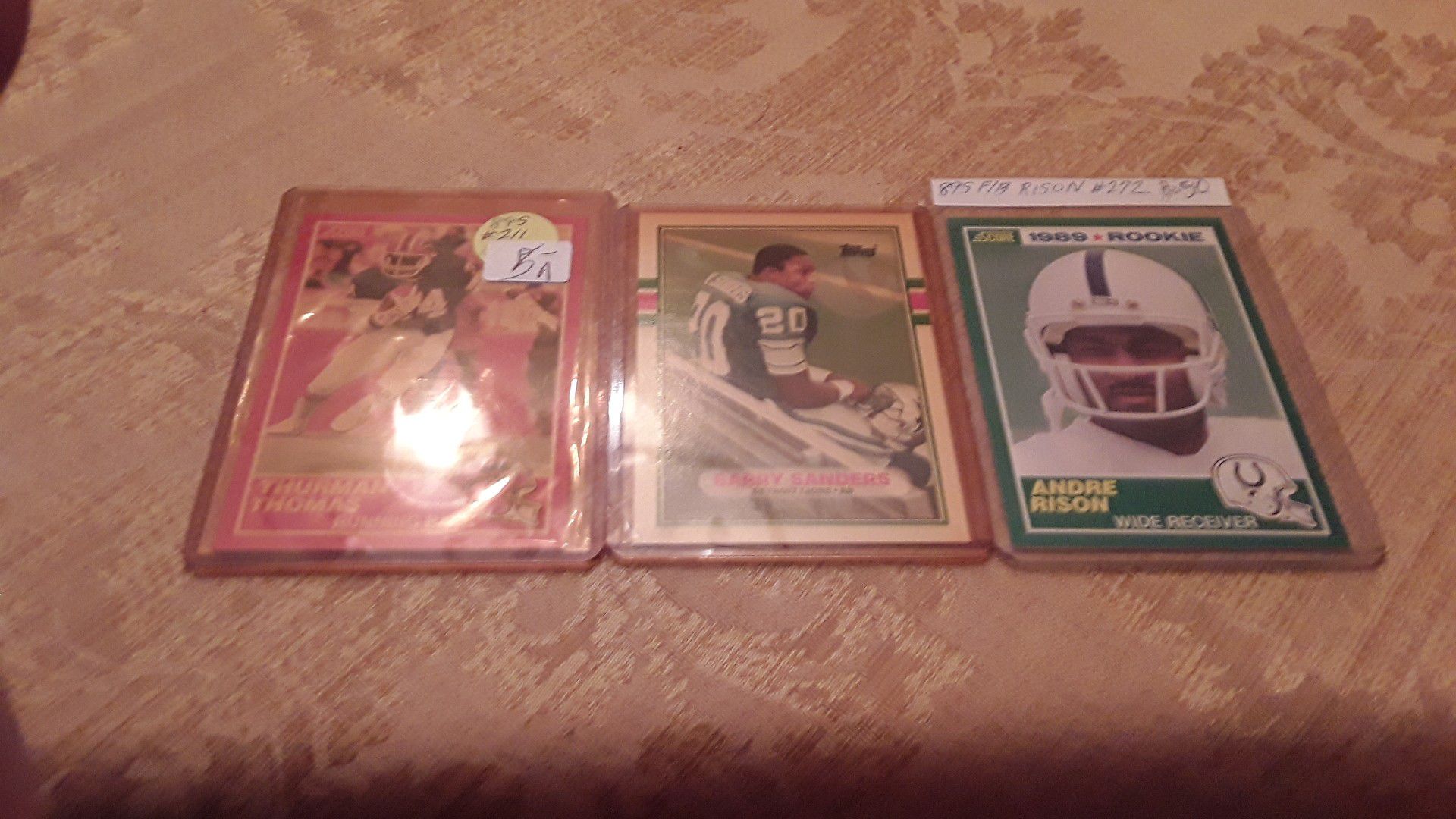 Barry Sanders, Thurman Thomas and Andre Rison rookie cards--- throw in an extra Sanders card