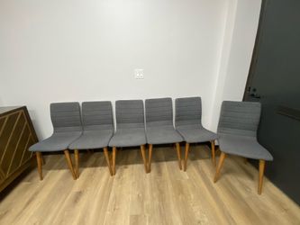 Six gray chairs used in an office