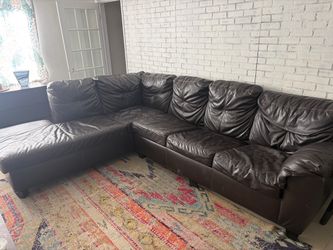 Dark brown faux leather sectional sofa with pullout bed