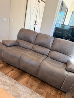 Gray Leather Reclining Sofa with Nailhead Trim