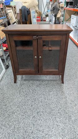 Glass door  wood storage cabinet.