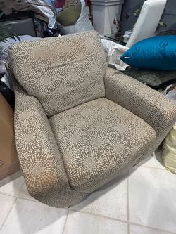 Brown and white chair with two pillow