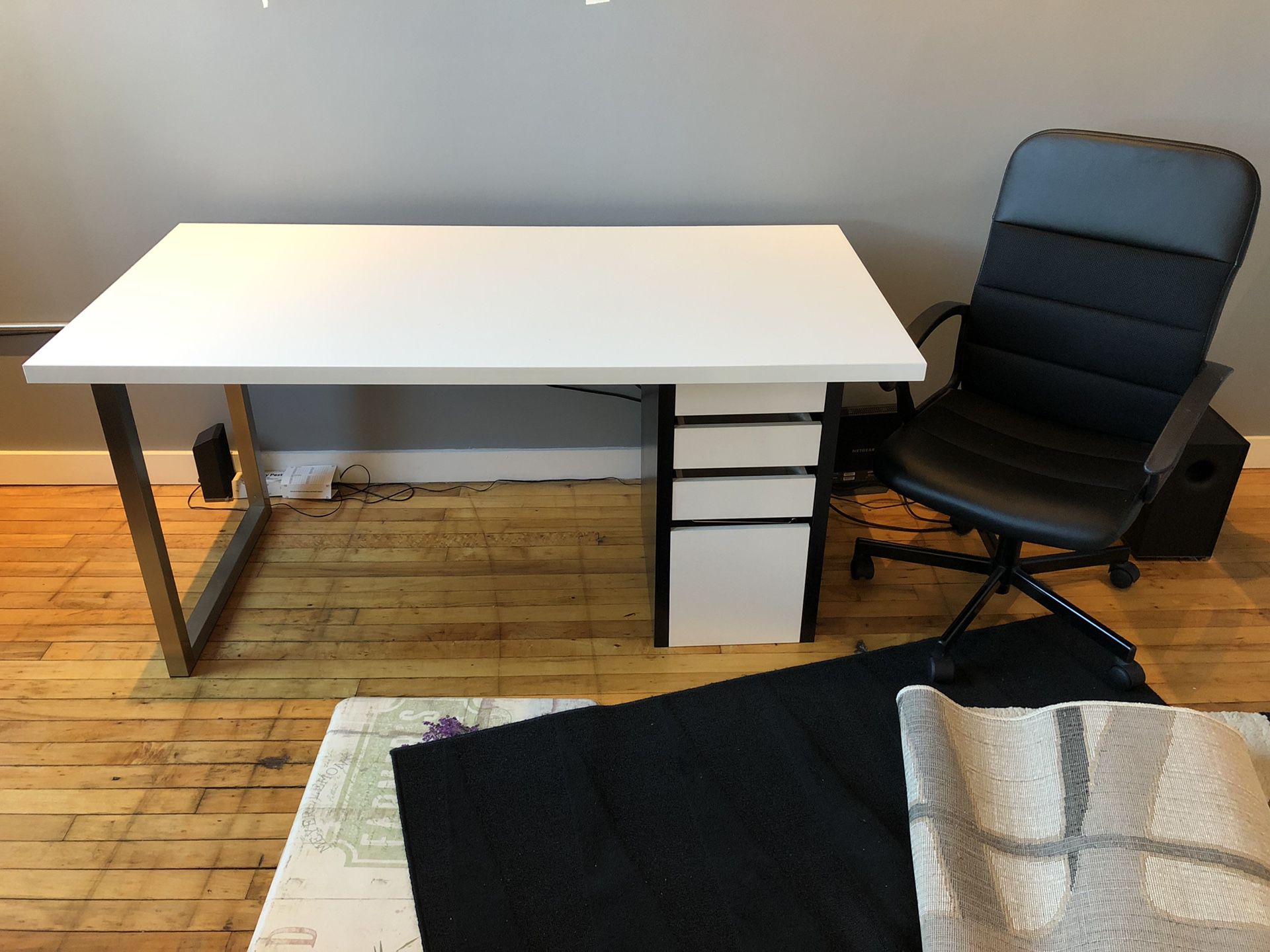Large modern black and white desk with rolling office chair