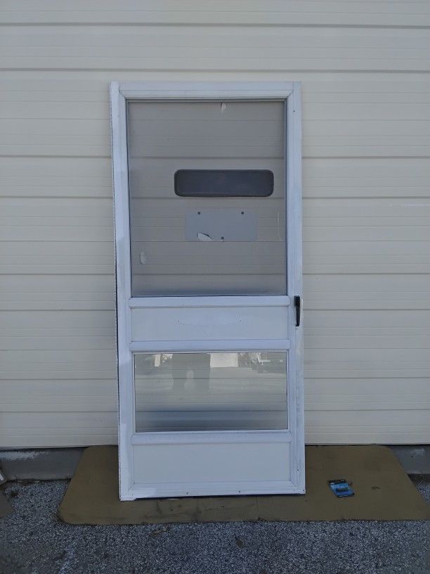 Nice White Storm Door With Doggy Window & Screen Plus Striker Very Clean Like New.