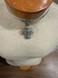 Cross pendant with choker.  I believe the cross is sterling silver but not sure