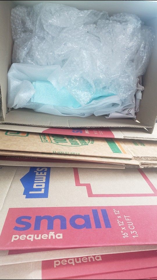 Bundle Of Moving Boxes With Packing Paper And Bubble Wrap
