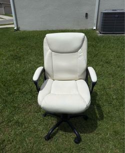 Selling white faux leather swivel office chair.