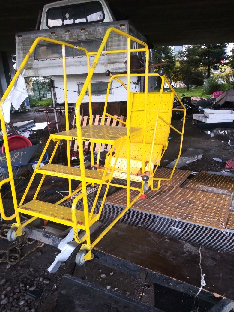 Rolling ladders. 1 orange ladder $500 or best offer. 3 yellow ladders 150 a piece or best offer