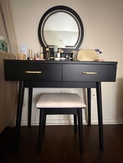 Black vanity desk set with large round mirror and matching stool