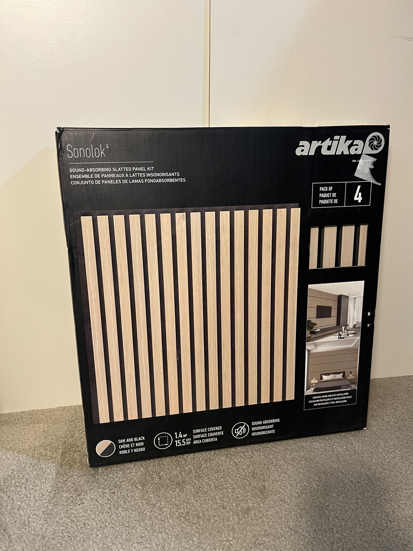 Open box Artika Sonolok Sound-Absorbing Slatted Panel Kit. 12 left. Oak on a black pad color.