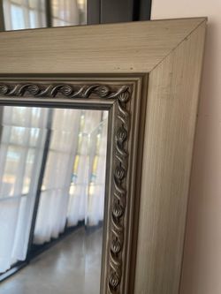 Silver framed beveled wall mirror