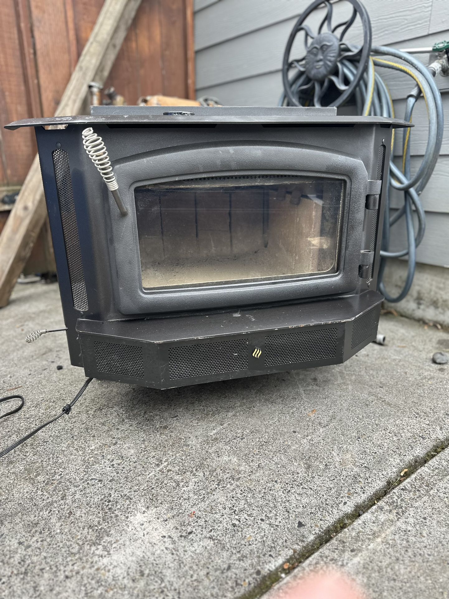Wood-burning fireplace insert with blower fan.