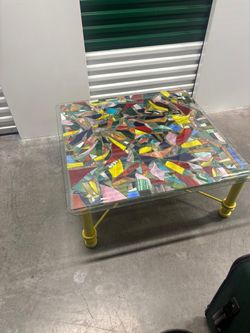 Stained glass indoors and outdoors, coffee table with yellow aluminum base. 38” x 38” .. 15” high. $200
