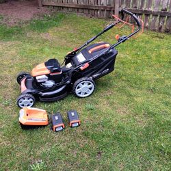 yard force 120 volt cordless self-propelled lawn mower with big wheels and charger with 2 batteries works great 