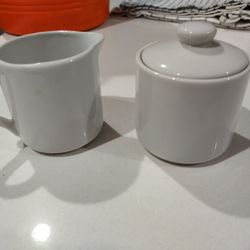 Two Different Sets Of Cream And Sugar Bowls