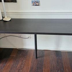 IKEA long office desk with adjustable legs
