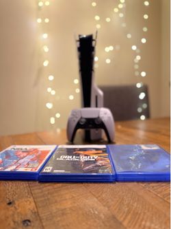 Excellent condition PlayStation 5 Slim Disc Edition console and 4 AAA games