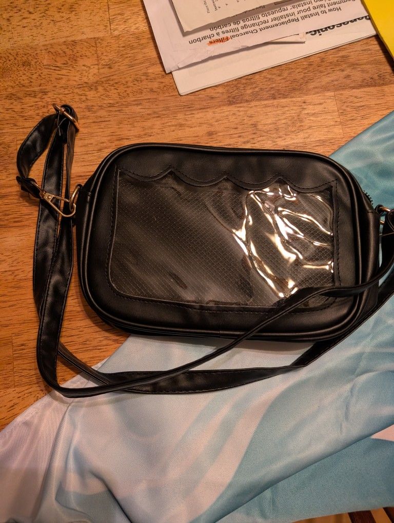 Black Cross Body Bag With Pin Display. 