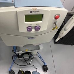 A Q-Switch Nd:YAG - professional-grade aesthetic device used for tattoo removal and treating pigmentation concerns such as dark spots, freckles, and s