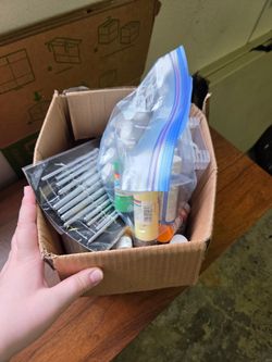 Large box of paint and paint supplies