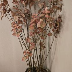 Artificial potted plant in a metal copper pot