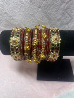 handcrafted red and gold bridal bangle set features intricately designed Kundan stones and traditional ghungroo bells