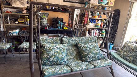 Outdoor swinging chair with cushions