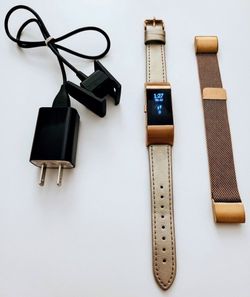 Fitbit charge 2 with a leather and metal mesh band tracks sleep, heart rate exercise and fitness smartwatch tracker