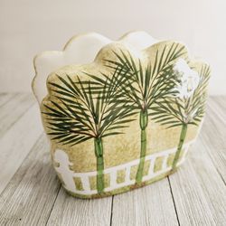 Palm Trees and White Fence Ceramic Decorative Napkin Holder Green Yellow White Home Decor. Measures 5"H x 5.75"L x 2.5"W.

Pre-owned in excellent clea