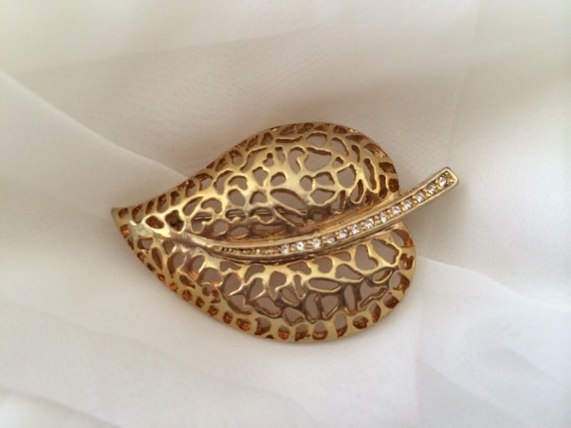 Gold colored brooch