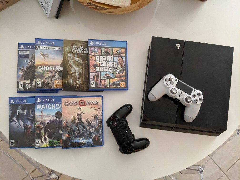 PlayStation 4 with 7 games and 2 controllers