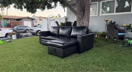 Black L-shaped sofa that converts into a bed