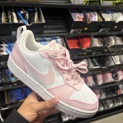 pink and white Nike shoes