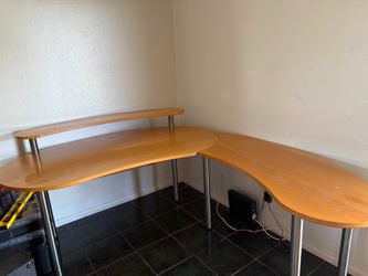 Large L-shaped desk with shelving.