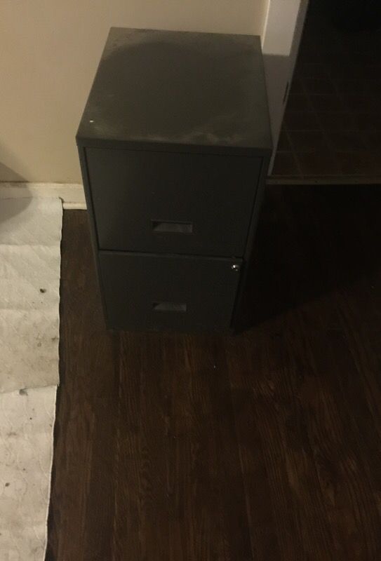 Two door grey file cabinet with lock and key