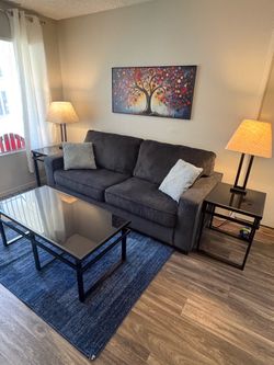 Sofa, tables, lamps, artwork, area rug
