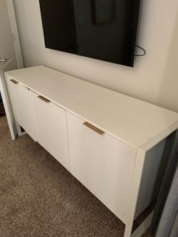 White storage sideboard with gold accents