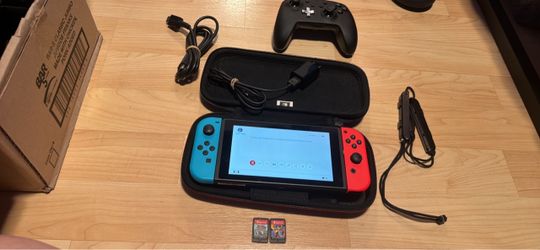 Nintendo switch with charger, two games, extra controller, case and wrist straps. No trade cash only see my other listings for more gaming stuff.