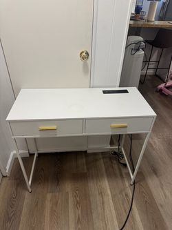 White desk with outlets and usb ports