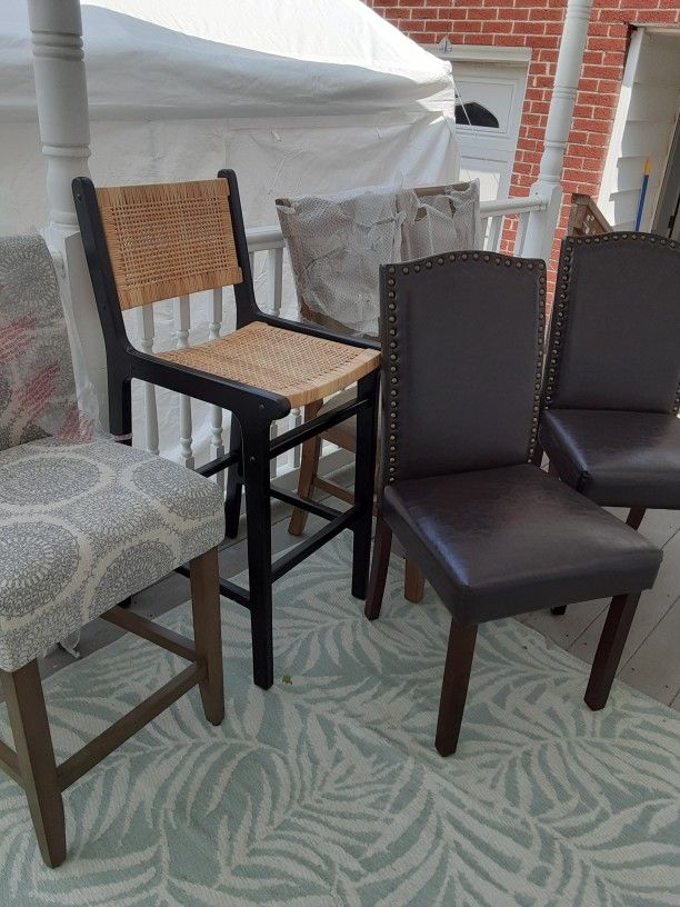 A Lot Of Different Chairs Some Tall Some Short