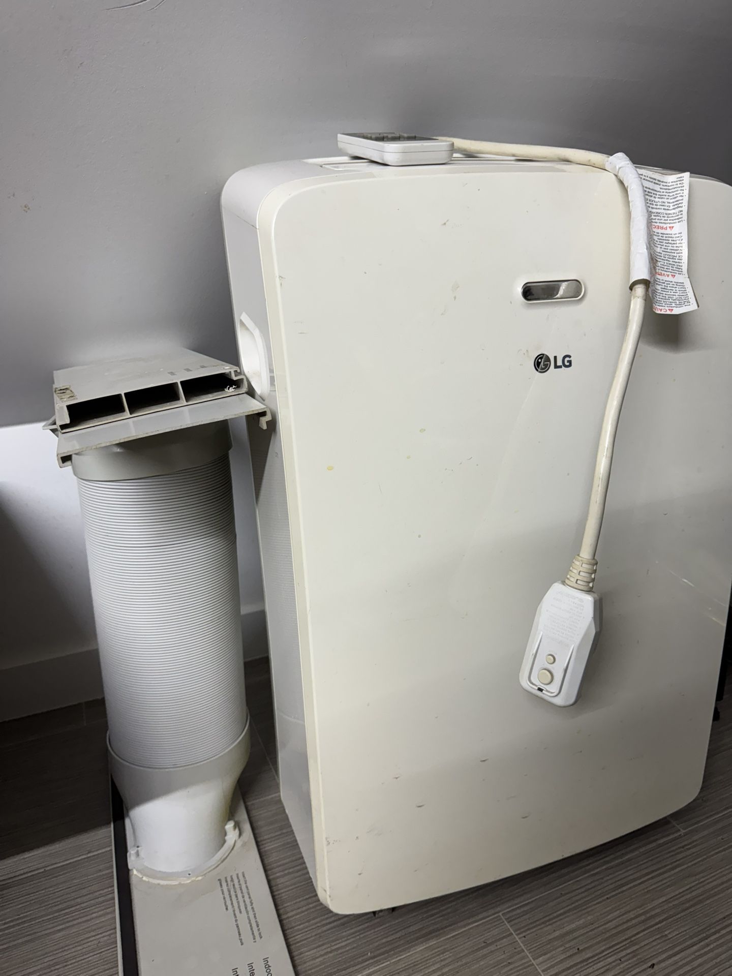 LG Portable Air Conditioner Cools 250 Sq. Ft. with Remote and Window Venting Kit in White