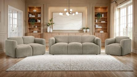 Sculptural sofa set wrapped in richly textured fabric and designed with a low-profile frame