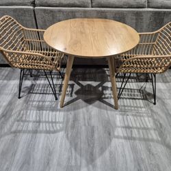 Wood Round Table With Two Rattan Chairs In Very Good Condition 
